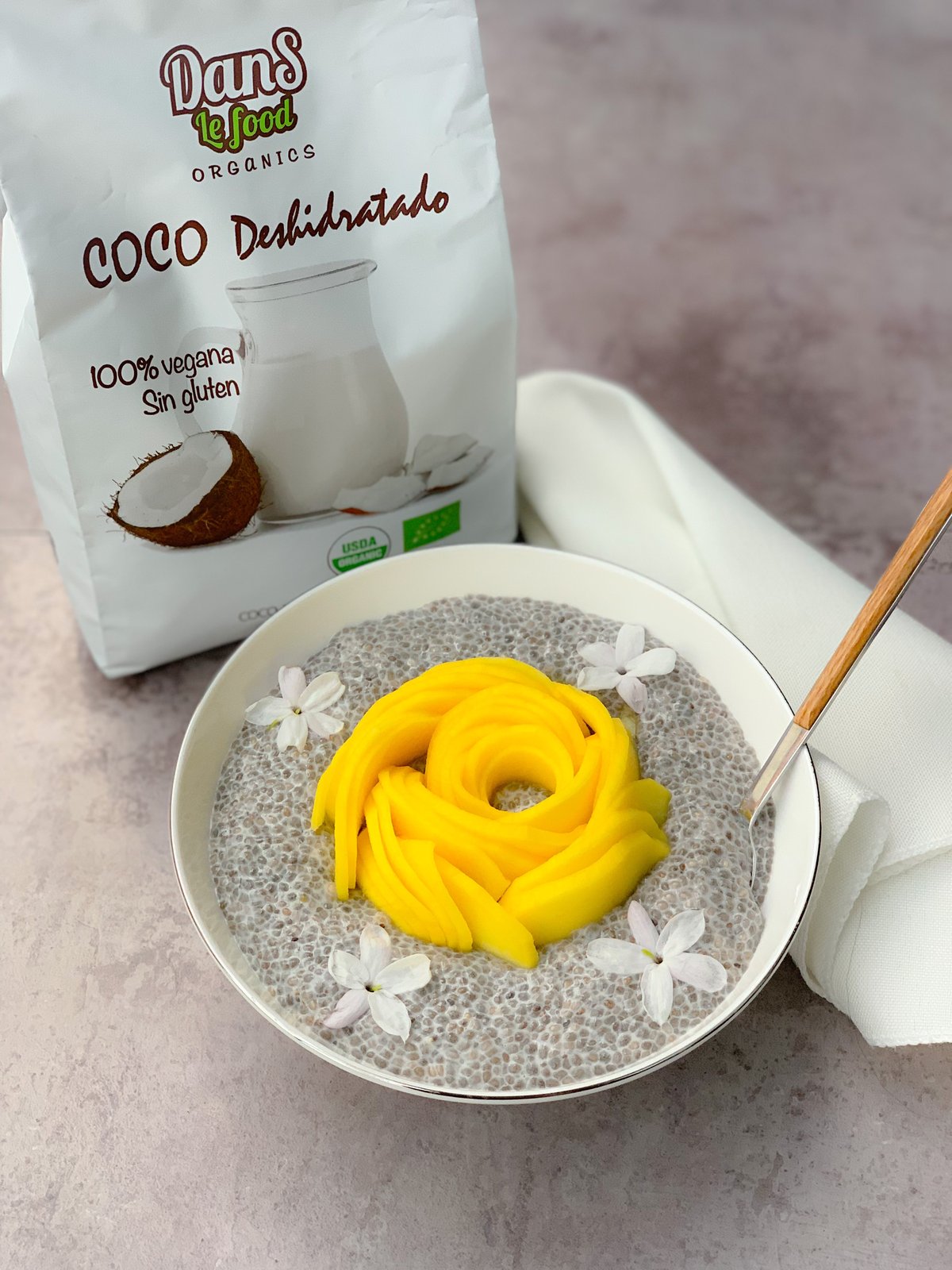 Chia pudding con leche de coco decorado con láminas de mango fresco en frasco de vidrio